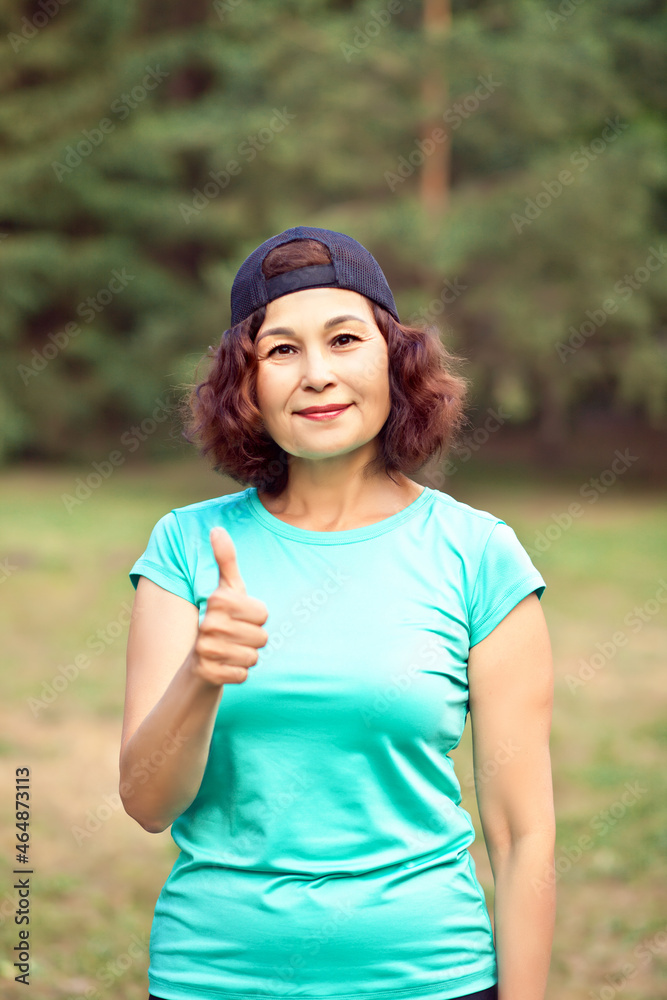 Senior middle age female woman running outdoors in a park Senior middle age female woman running outdoors in a park