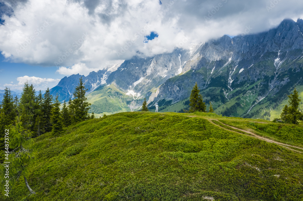 Traveler man on hiking trail enjoying Wilder Kaiser mountains, Tirol - Austria Traveler man on hiking trail enjoying Wilder Kaiser mountains, Tirol - Austria