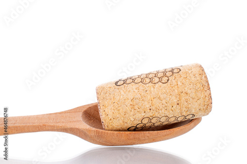 One wine cork with a spoon made of wood, close-up, isolated on white.