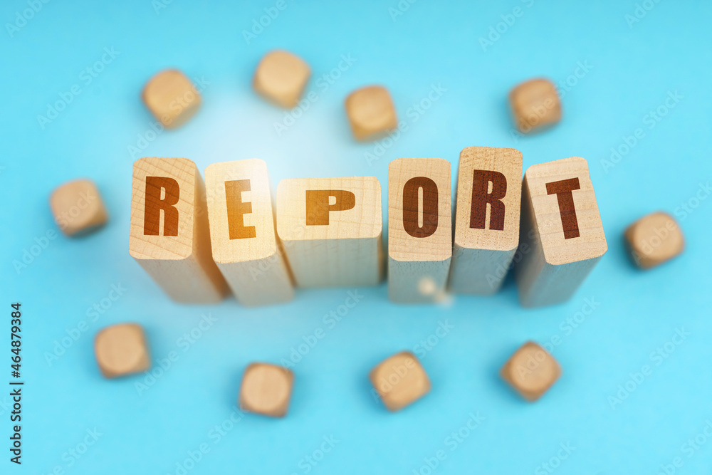 On a blue background, wooden cubes and Jenga with the inscription - REPORT On a blue background, wooden cubes and Jenga with the inscription - REPORT
