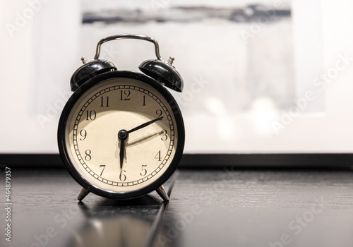 Close-up of a vintage alarm clock on a blurred background.