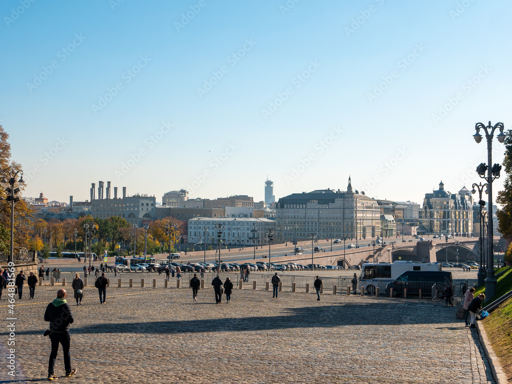 Moscow, Russia - October 5, 2021: View of the Moskvoretsky bridge and the architecture of the capital. People walk along the red square. Copy space.