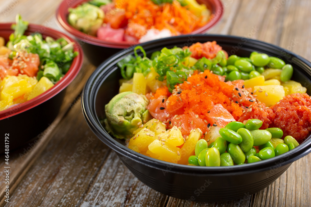 A view of three customized poke bowls. A view of three customized poke bowls.