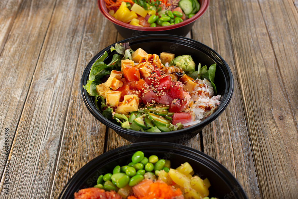 A view of a row of poke bowls. A view of a row of poke bowls.