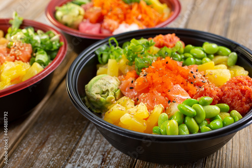 A view of three customized poke bowls. 