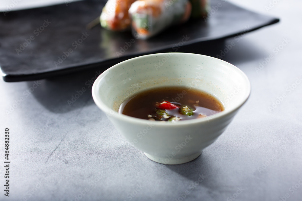A view of a spicy dipping sauce for spring rolls. A view of a spicy dipping sauce for spring rolls.