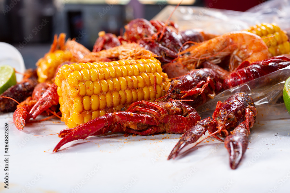 A closeup view of a pile of crawfish boil spilling out of a plastic bag.  Stock-Foto | Adobe Stock