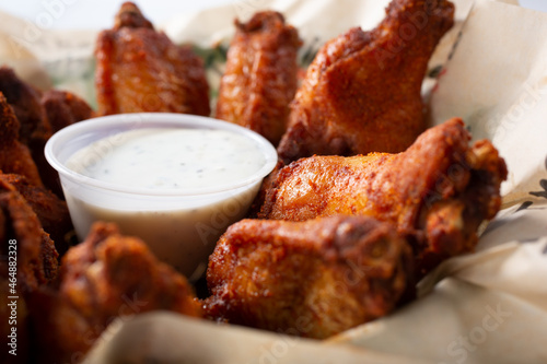 A closeup view of a plate of seasoned chicken wings.