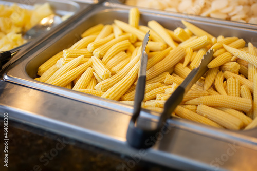 A view of a steamer pan filled with baby corn  seen at a local buffet restaurant.