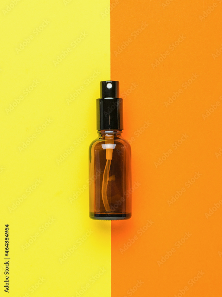 Brown bubble spray on a yellow and orange background.