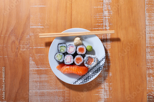 Top view of a white plate with some sushis and a sashimis photo