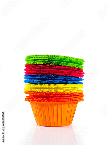 Lots of multi color paper cupcake baking pans. Isolated on white background