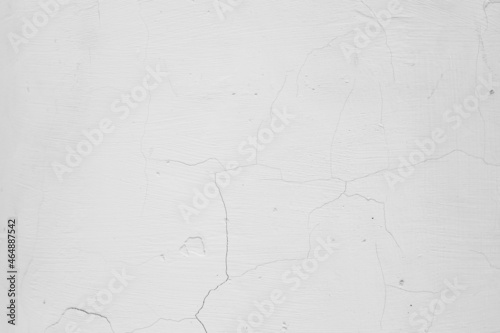 White and gray wall with cracks. The texture of concrete and cement. Plaster. Grunge background. Old concrete surface.
