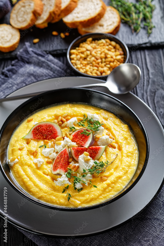Pumpkin cream soup with thyme with feta and figs