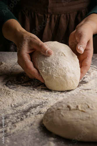 Closeup of women hands kneading dough