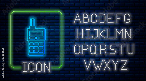 Glowing neon Walkie talkie icon isolated on brick wall background. Portable radio transmitter icon. Radio transceiver sign. Neon light alphabet. Vector