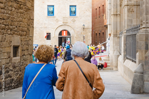 Two senior ladies having fun sightseeing in the city. Friends old women taking a walk through the streets of Barcelona