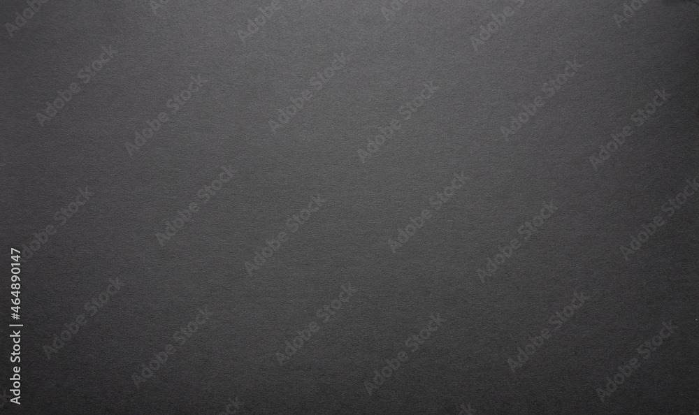 The paper background is black. Gloomy background for the text. The texture of dark cardboard. The paper background is black. Gloomy background for the text. The texture of dark cardboard.