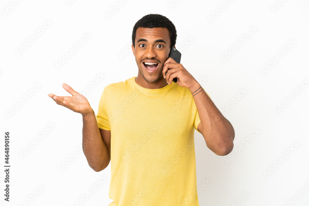 African American handsome man using mobile phone over isolated white background with shocked facial expression African American handsome man using mobile phone over isolated white background with shocked facial expression