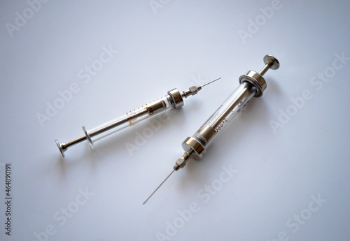 Medical glass syringes on white isolate. A classic syringe. Vaccination.