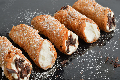Homemade sicilian cannoli with ricotta and chocolate chips. Shallow DOF. photo