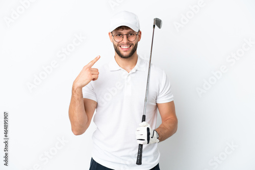 Handsome young man playing golf isolated on white background giving a thumbs up gesture