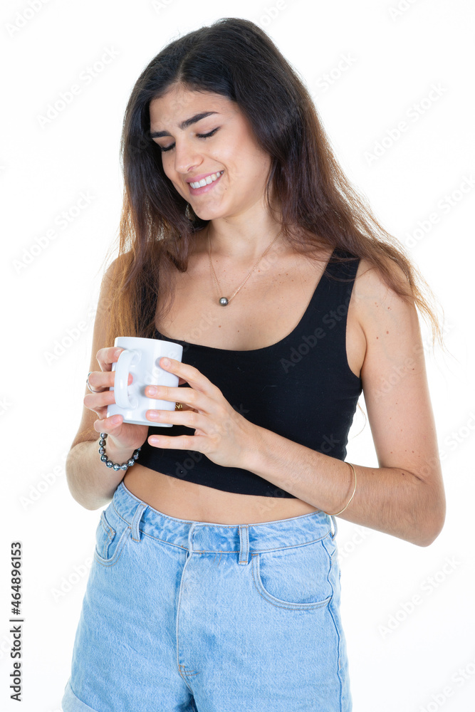Young brunette woman looking holding hot cup of coffee mug Young brunette woman looking holding hot cup of coffee mug