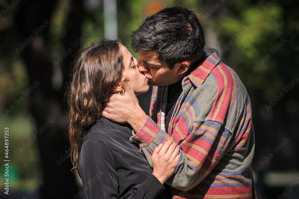 Fototapeta premium Couple in love hugging and kissing in park. French deep kiss.