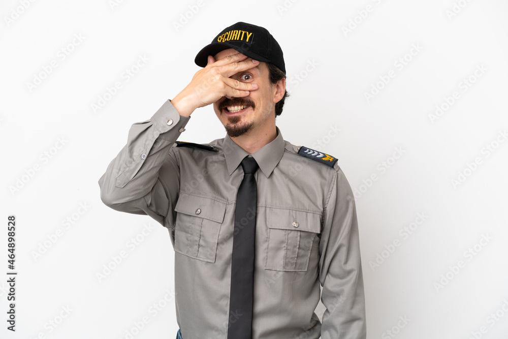Young caucasian security man isolated on white background covering eyes by hands and smiling Young caucasian security man isolated on white background covering eyes by hands and smiling
