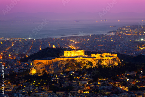 Athens postcard. Sunset view of Parthenon Temple at the Acropolis Hill, Athens and harbour. View from Mount Lycabettus. Athens, Greece