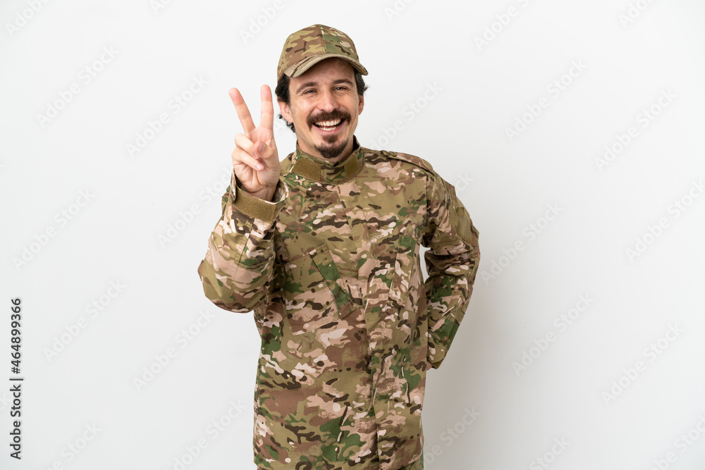 Soldier man isolated on white background smiling and showing victory sign Soldier man isolated on white background smiling and showing victory sign