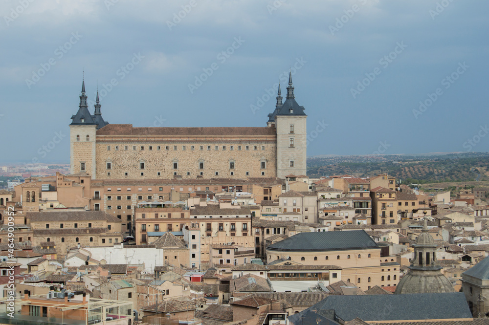 View of the Alcazar and rooftops of Toledo from one of the towers of the Jesuit church in Toledo. Spain