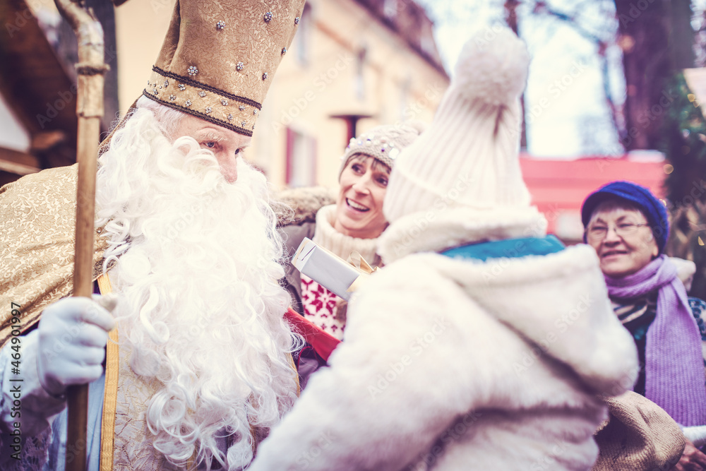 St Nicholas and an extended family with child on the Christmas market