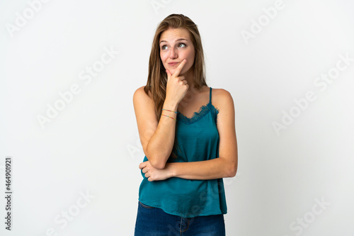 Young caucasian woman over isolated background having doubts
