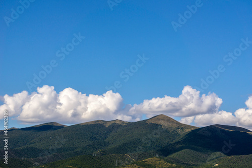 Mountains of the North Caucasus against the blue sky with clouds. © Nikolay Beletskiy
