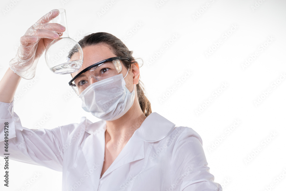 Laboratory assistant or research student in a white coat. A young female doctor in a white lab coat Laboratory assistant or research student in a white coat. A young female doctor in a white lab coat