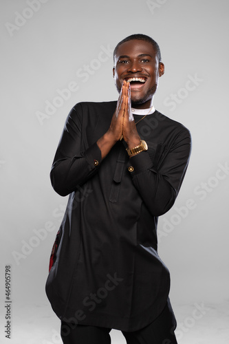 Obraz na plátně excited and happy young black man in a wishful prayerful mood