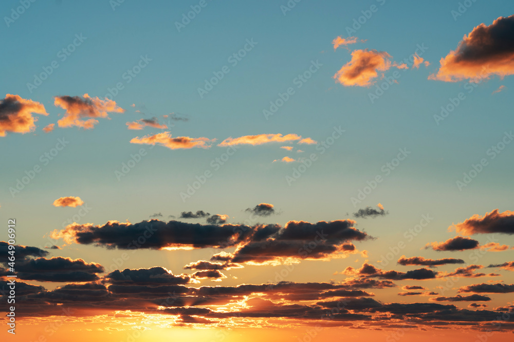 Beautiful bright sunset over the sea and sky with clouds.