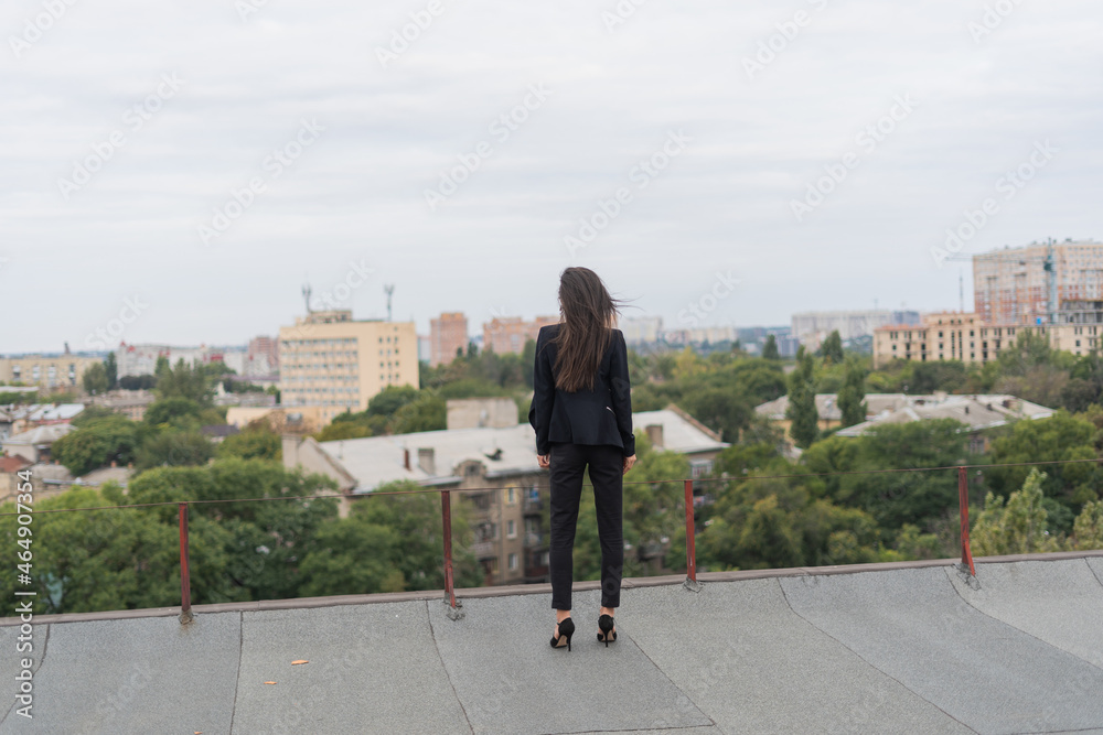 woman standing and looking at the city