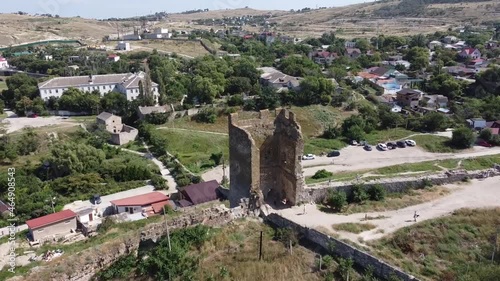 Drone flight over the Tower of ancient ruined Genoese fortress Kaffa. Aerial dolly shot.
