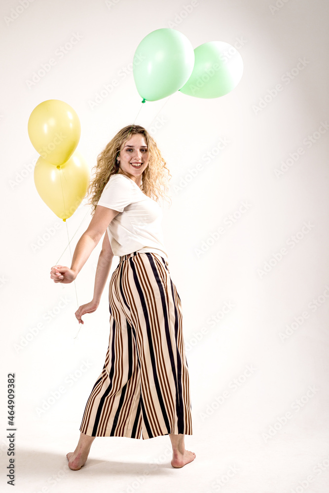 Funny girl with colored balls on a white background. (isolated on white) Funny girl with colored balls on a white background. (isolated on white)