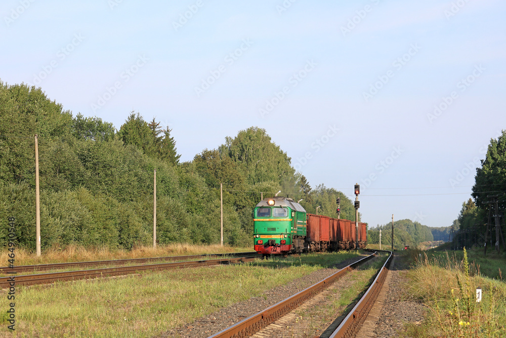early sunny morning freight train arrives at railway station early sunny morning freight train arrives at railway station