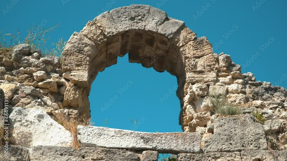 Ruins of an ancient castle, in the form of a stone arch of a window opening Ruins of an ancient castle, in the form of a stone arch of a window opening