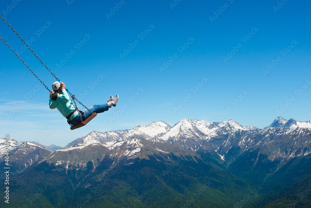 Swing over the abyss, light extreme, entertainment. The feeling of freedom and flight in the mountains. Swing over the abyss, light extreme, entertainment. The feeling of freedom and flight in the mountains.