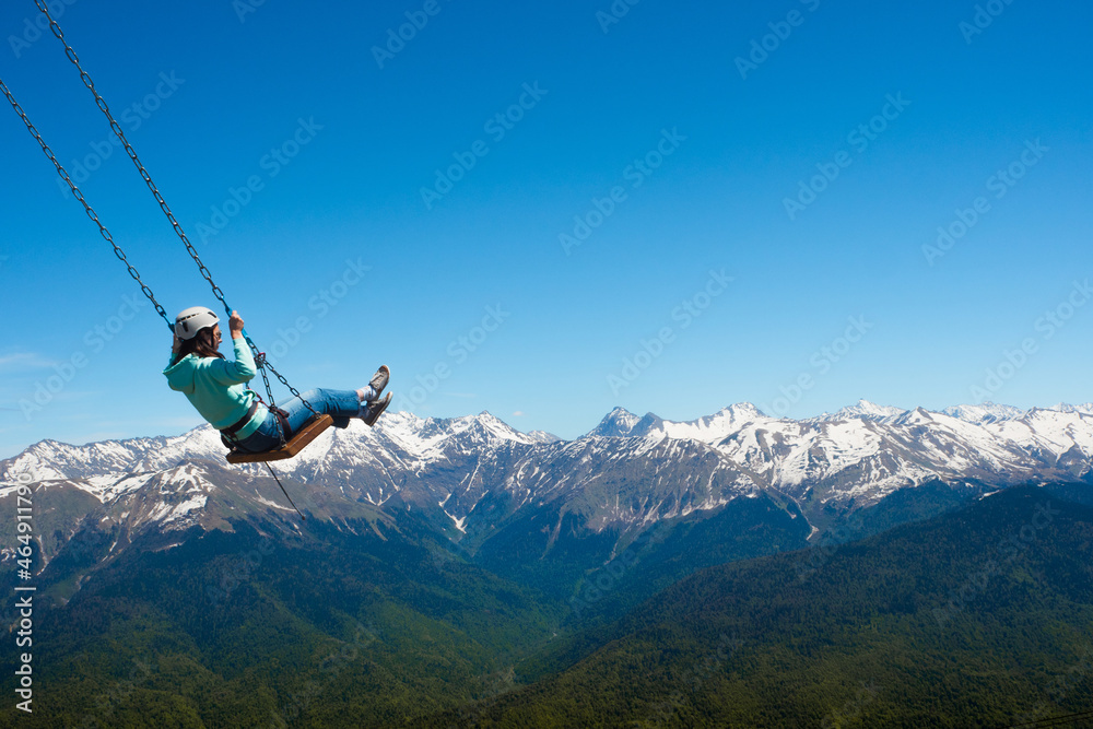 Swing over the abyss, light extreme, entertainment. The feeling of freedom and flight in the mountains. Swing over the abyss, light extreme, entertainment. The feeling of freedom and flight in the mountains.