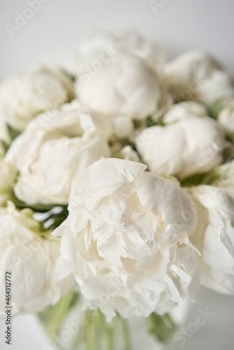 White peonies in a glass vase. Beautiful peony flower for catalog or online store. Floral shop concept . Beautiful fresh cut bouquet. Flowers delivery