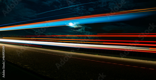 lights of cars with night. long exposure, moon and sky