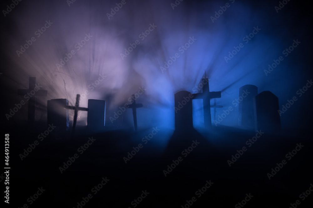 Scary view of zombies at cemetery dead tree, moon, church and spooky cloudy sky with fog, Horror Halloween concept with glowing pumpkin. Selective focus