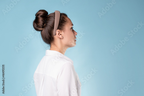 calm portrait in profile, a young beautiful woman in a white shirt,