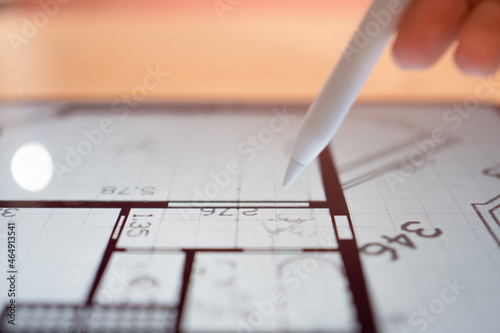 Interior Designer is working on a floor plan of a building on a mobile